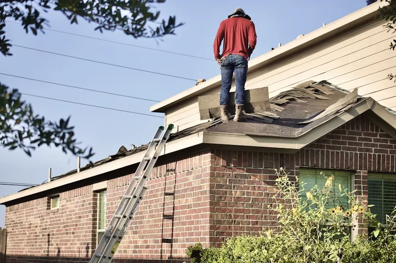 Professional roofer working on a residential roof in Huntington Acres